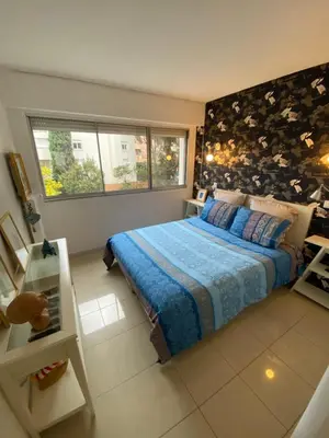 a bedroom with a large bed with a blue blanket at Grand appartement de style avec parking - Cannes in Cannes