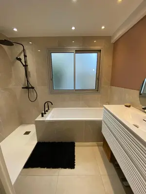 a bathroom with a bath tub and a window at Grand appartement de style avec parking - Cannes in Cannes