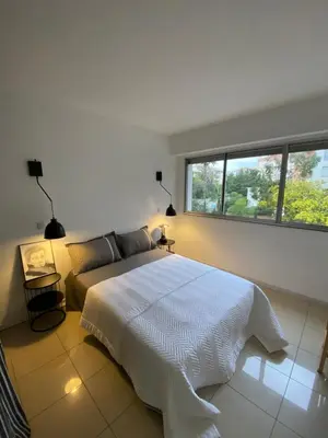a bedroom with a large white bed and a window at Grand appartement de style avec parking - Cannes in Cannes