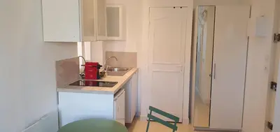 a small white kitchen with a sink and a counter at Le Suquet in Cannes