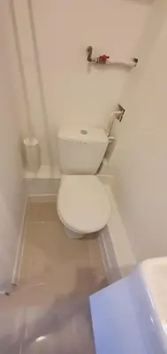 a white bathroom with a toilet and a sink at Le Suquet in Cannes