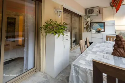 a kitchen with a table with a plant on it at Ô 27 Fleurie Cannes in Cannes