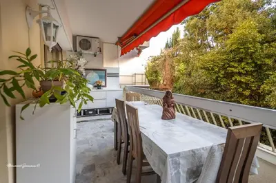 a table and chairs on the balcony of a house at Ô 27 Fleurie Cannes in Cannes