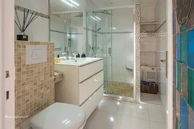 a bathroom with a toilet and a sink and a shower at Ô 27 Fleurie Cannes in Cannes