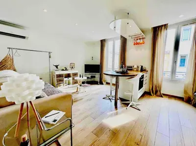 a living room with a couch and a table at Cannes centre , magnifique , 5 min palais in Cannes