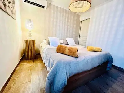 a bedroom with a large bed with two pillows on it at Cannes centre , magnifique , 5 min palais in Cannes