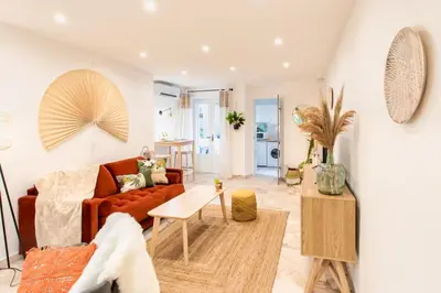 a living room with a couch and a table at C6 - Studio Rue Félix Faure 2 min Palais Festivals - AC & Balcony in Cannes