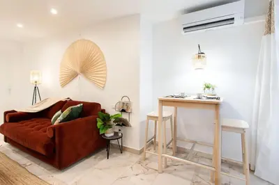 a living room with a brown couch and a table at C6 - Studio Rue Félix Faure 2 min Palais Festivals - AC & Balcony in Cannes