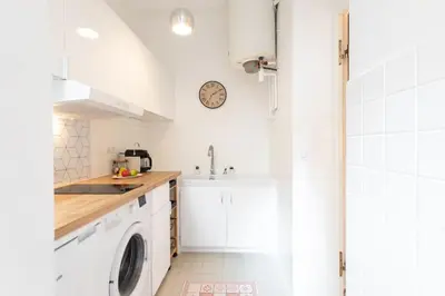 a white kitchen with a sink and a washing machine at C6 - Studio Rue Félix Faure 2 min Palais Festivals - AC & Balcony in Cannes