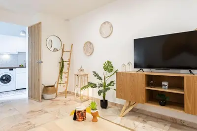 a living room with a large flat screen tv at C6 - Studio Rue Félix Faure 2 min Palais Festivals - AC & Balcony in Cannes