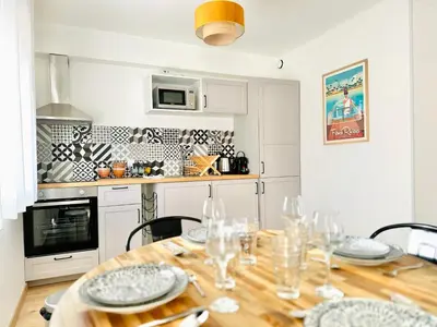 a kitchen with a wooden table with glasses on it at Le CozyCroisette - Centre Cannes - 6 personnes in Cannes