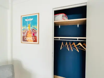 a room with a closet with a blue wall at Le CozyCroisette - Centre Cannes - 6 personnes in Cannes