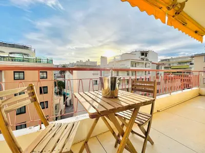 a balcony with a table and chairs on a roof at Le CozyCroisette - Centre Cannes - 6 personnes in Cannes