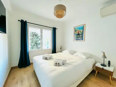a white bedroom with a large white bed with two pillows at Le CozyCroisette - Centre Cannes - 6 personnes in Cannes