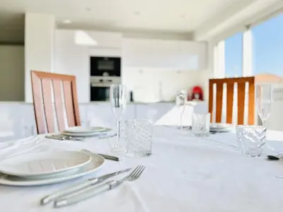 a white table with plates and glasses and silverware at Le Panoramique - 4 pièces centre Cannes in Cannes