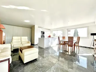 a kitchen and living room with a table and chairs at Le Panoramique - 4 pièces centre Cannes in Cannes