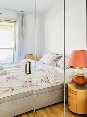 a bedroom with a bed with a glass wall at Cannes Center - Appartement 2 pièces avec terrasse in Cannes