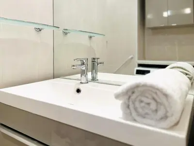 a bathroom with a sink with a towel on it at Cannes Center - Appartement 2 pièces avec terrasse in Cannes