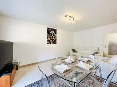 a living room with a glass table and a couch at Cannes Center - Appartement 2 pièces avec terrasse in Cannes