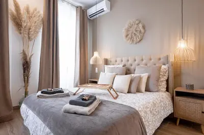 a bedroom with a large bed with towels on it at L'atelier des Artistes -Écrin de sérénité au coeur de Cannes - Balcon - Clim - Wifi in Cannes