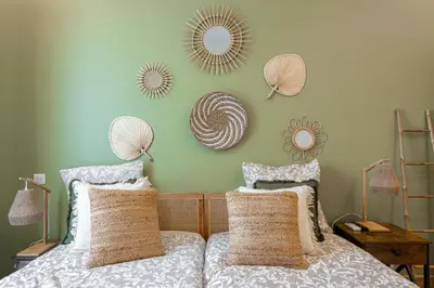 a bedroom with a bed with two mirrors on the wall at L'atelier des Artistes -Écrin de sérénité au coeur de Cannes - Balcon - Clim - Wifi in Cannes