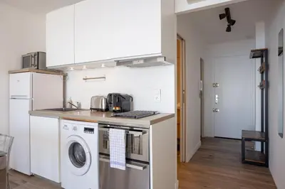 a kitchen with a washer and dryer on a counter at The Beach Cocoon – Sea View & Calm in Cannes