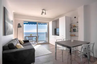 a living room with a couch and a table at The Beach Cocoon – Sea View & Calm in Cannes