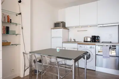 a kitchen with a table and chairs in it at The Beach Cocoon – Sea View & Calm in Cannes