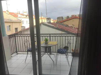 a view of a balcony with a table and chairs at LE PALAZZIO - Proximité immédiate Palais des festival ,Vieux Port et plages - Garage in Cannes