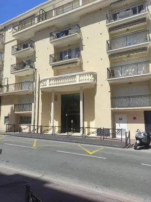 a building with a motorcycle parked in front of it at LE PALAZZIO - Proximité immédiate Palais des festival ,Vieux Port et plages - Garage in Cannes