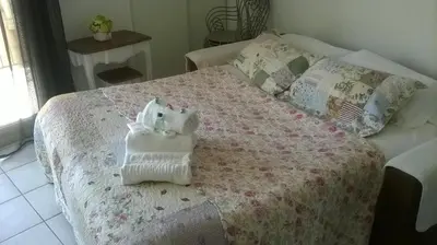 a bed with a stuffed animal sitting on top of it at LE PALAZZIO - Proximité immédiate Palais des festival ,Vieux Port et plages - Garage in Cannes