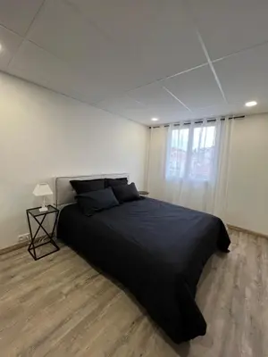 a bedroom with a large bed in a white room at Ciel de Cannes in Cannes