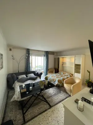 a living room with a bed and a couch at Cool Appart sur Croisette Palm Beach in Cannes