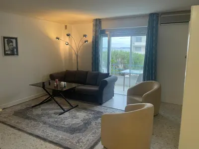 a living room with a couch and a table at Cool Appart sur Croisette Palm Beach in Cannes