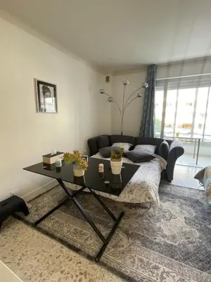 a living room with a couch and a table at Cool Appart sur Croisette Palm Beach in Cannes