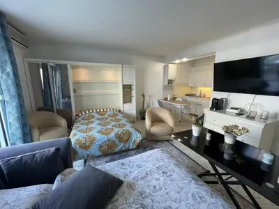 a living room with a bed and a kitchen at Cool Appart sur Croisette Palm Beach in Cannes