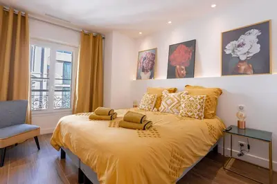 a bedroom with a large yellow bed with a window at Luxury Apt With Balcony On Famous Rue D'antibes! - Kiss Apartment by Halldis in Cannes
