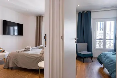 a bedroom with a bed and a room with a window at Luxury Apt With Balcony On Famous Rue D'antibes! - Kiss Apartment by Halldis in Cannes