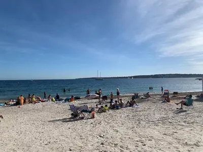 a group of people sitting on a beach at Beau studio - 100m de la plage Palm beach in Cannes