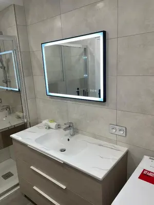 a bathroom with a sink and a mirror at Modern and pleasant apartment in the heart of the city in Cannes