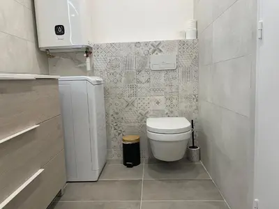 a small bathroom with a toilet and a sink at Modern and pleasant apartment in the heart of the city in Cannes