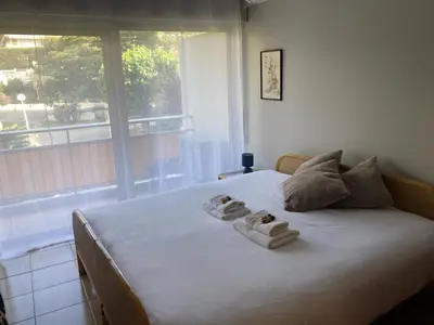 a bedroom with a large bed with towels on it at Le Trident in Cannes
