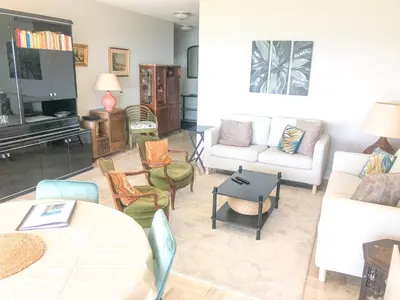 a living room with a couch and a table at Le Trident in Cannes