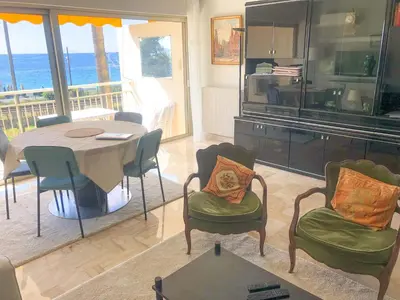 a living room with a dining room table and chairs at Le Trident in Cannes