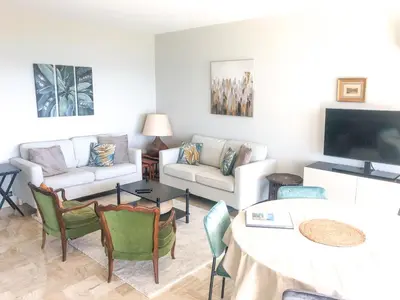 a living room with a couch and a table at Le Trident in Cannes