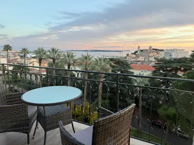 a bedroom with a large bed in a white room at NEWLY RENOVATED! Harbour View on Balcony Terrace in Cannes