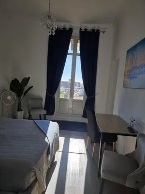 an empty room with a chandelier and a large door at NEWLY RENOVATED! Harbour View on Balcony Terrace in Cannes