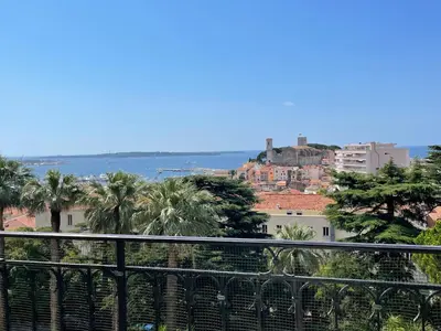 a balcony with a table and chairs and the ocean at NEWLY RENOVATED! Harbour View on Balcony Terrace in Cannes