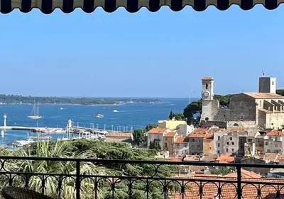 a view of a city and the ocean from a balcony at NEWLY RENOVATED! Harbour View on Balcony Terrace in Cannes