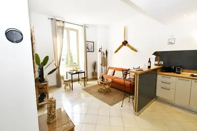 a kitchen and living room with a couch and a table at Tou'Can YourHostHelper in Cannes